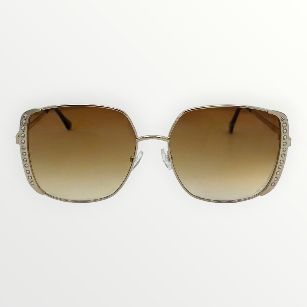 Sunglasses with brown gradient lenses and decorative frame on a white background