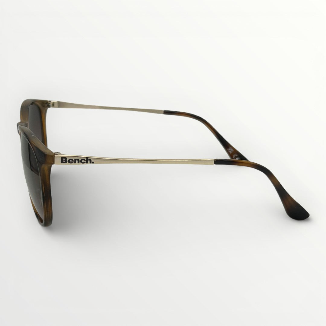 Sunglasses with tortoiseshell frame and dark lenses on a white background