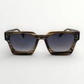 Sunglasses with tortoiseshell frame and dark lenses on a white background