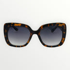 Sunglasses with tortoiseshell frame and dark lenses on a white background