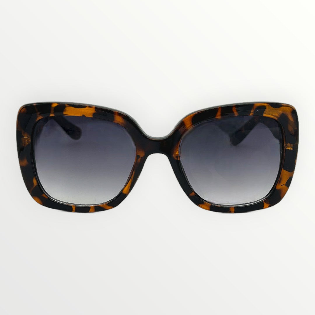 Sunglasses with tortoiseshell frame and dark lenses on a white background