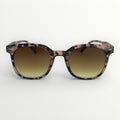 Sunglasses with a tortoiseshell frame and gradient lenses on a white background