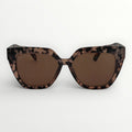 Sunglasses with leopard print frame and brown lenses on a white background
