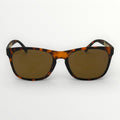 Sunglasses with tortoiseshell frame and brown lenses on a white background