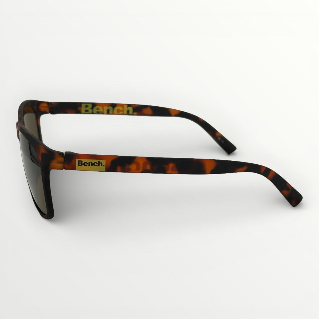 Sunglasses with tortoiseshell frame and 'Bench' logo on a white background