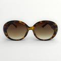 Sunglasses with tortoiseshell frame and brown gradient lenses on a white background