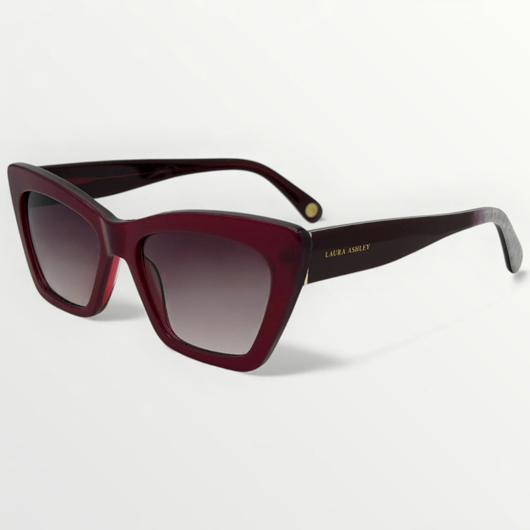 Sunglasses with a maroon frame and gradient lenses on a white background
