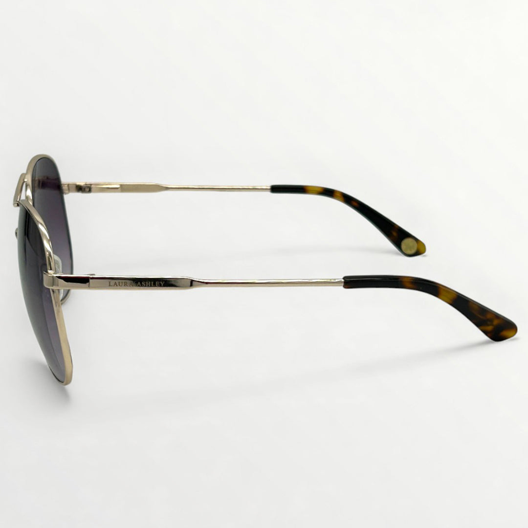 Sunglasses with gold frame and tortoiseshell accents on a white background