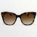 Sunglasses with tortoiseshell frame and brown gradient lenses on a white background