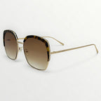 Sunglasses with gold frame and gradient lenses on a white background