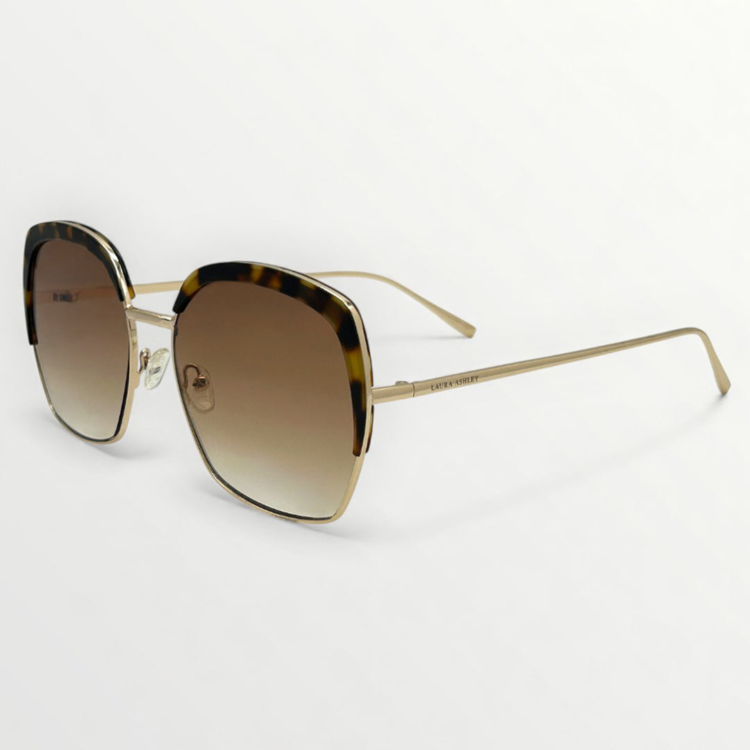 Sunglasses with gold frame and gradient lenses on a white background