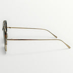 Sunglasses with gold frame and dark lenses on a white background