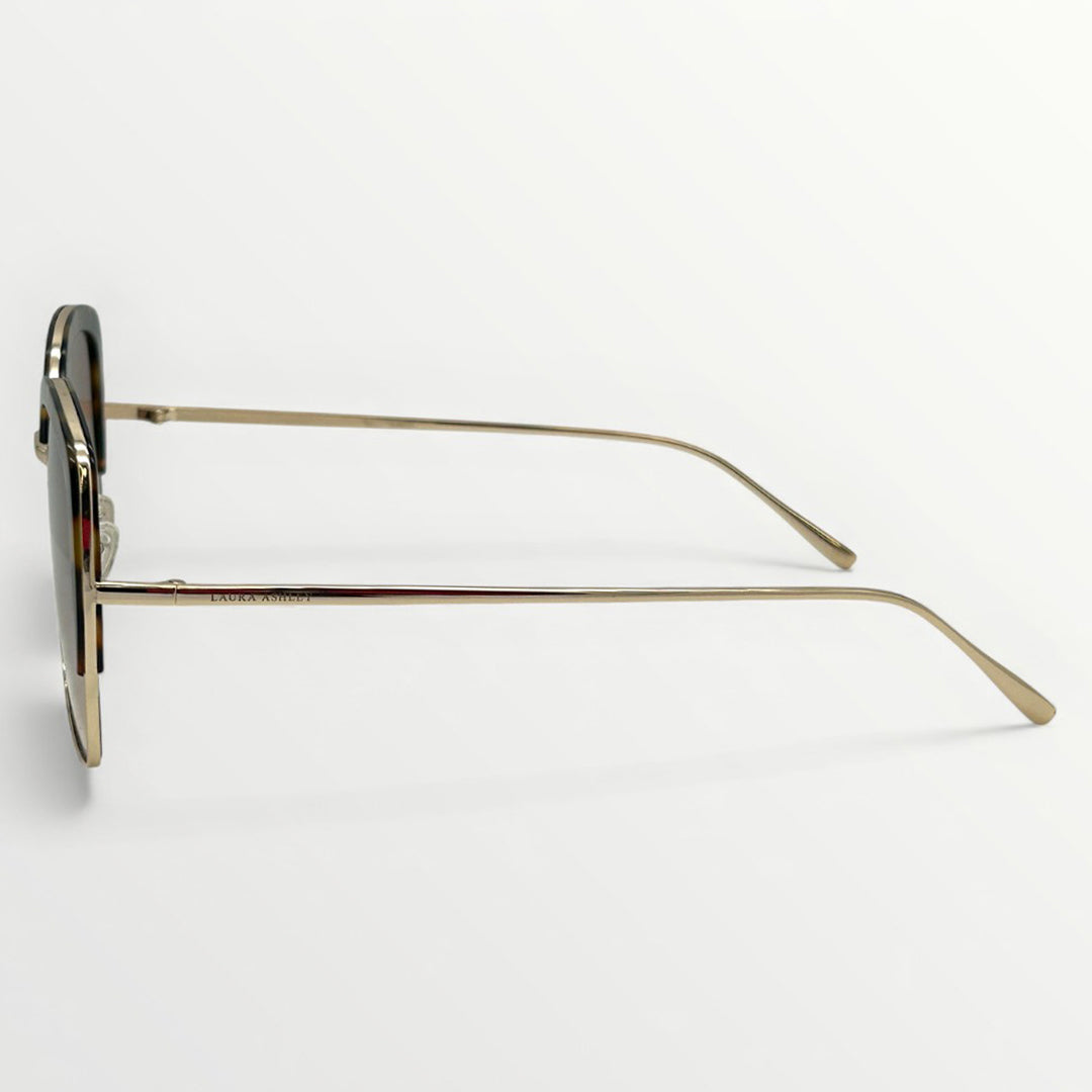 Sunglasses with gold frame and dark lenses on a white background