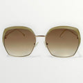 Sunglasses with gold frame and brown gradient lenses on a white background