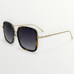 Sunglasses with tortoiseshell frame and dark lenses on a white background