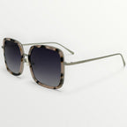 Sunglasses with tortoiseshell frame and dark lenses on a white background