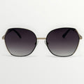 Sunglasses with dark gradient lenses and gold frame on a white background