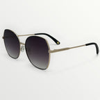 Sunglasses with gold frame and black gradient lenses on a white background