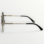 Sunglasses with gold frame and black arms on a light gray background