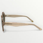 Sunglasses with a beige frame on a light gray background