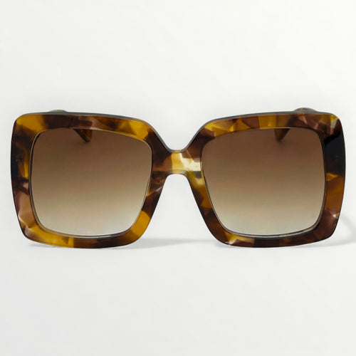 Sunglasses with tortoiseshell frame and brown gradient lenses on a white background