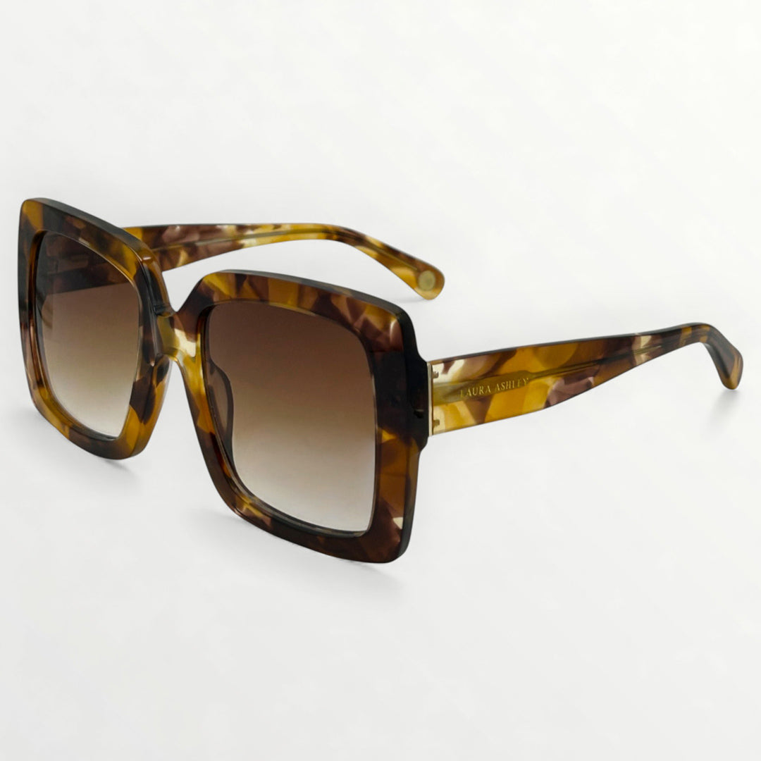 Sunglasses with tortoiseshell frame and brown gradient lenses on a white background