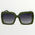 Green sunglasses with dark lenses on a light gray background