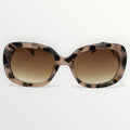 Sunglasses with tortoiseshell frame and brown gradient lenses on a white background