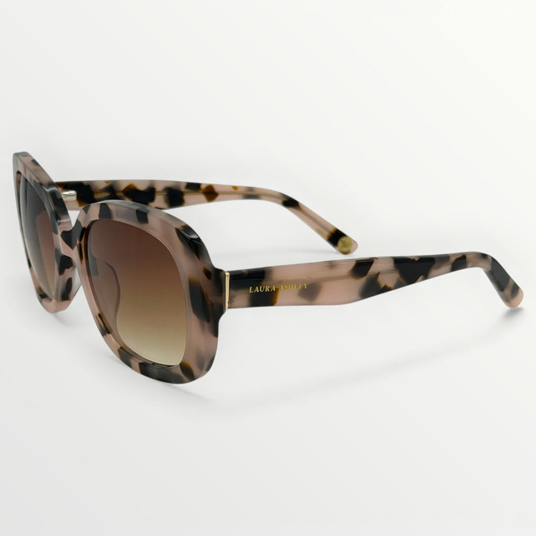 Sunglasses with tortoiseshell frame and gradient lenses on a white background