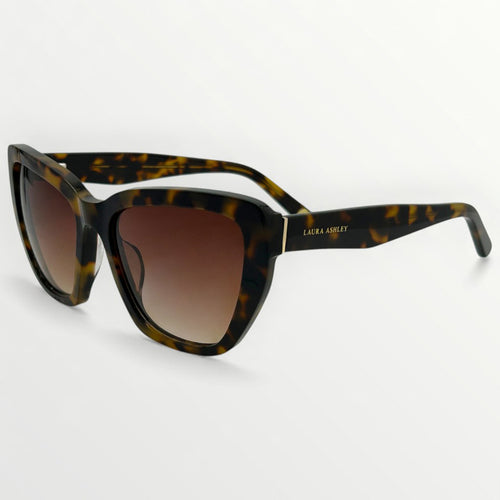Tortoiseshell sunglasses with brown gradient lenses on a white background