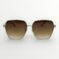 Sunglasses with brown gradient lenses and gold frame on a white background