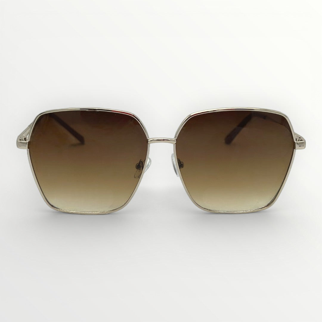 Sunglasses with brown gradient lenses and gold frame on a white background