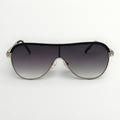 Sunglasses with a black gradient lens and gold frame on a white background