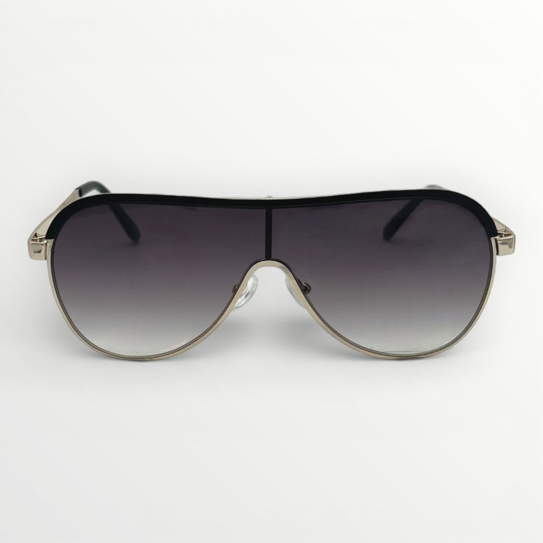 Sunglasses with a black gradient lens and gold frame on a white background
