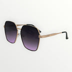 Sunglasses with gradient purple lenses and gold frame on a white background