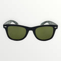 Black sunglasses with green lenses on a white background