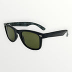 Black sunglasses with green lenses on a white background