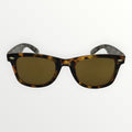 Sunglasses with tortoiseshell frame and gold lenses on a white background