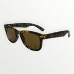 Sunglasses with tortoiseshell frame and gold lenses on a white background