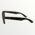 Sunglasses with tortoiseshell frame and gold lenses on a white background