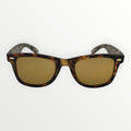 Sunglasses with tortoiseshell frame and gold lenses on a white background
