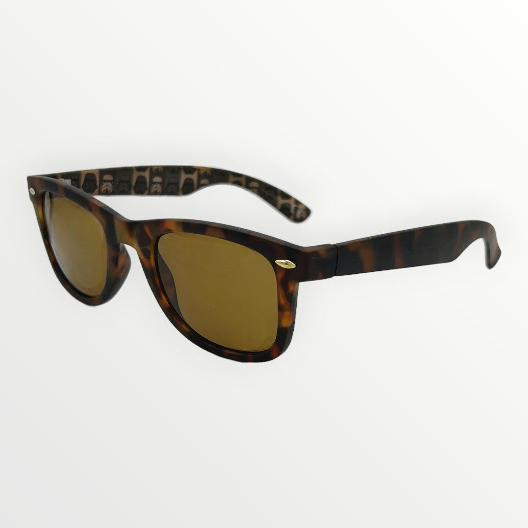 Sunglasses with tortoiseshell frame and gold accents on a white background